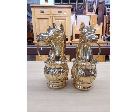A pair of brass gate post terminals modelled as horses heads, length 29.5cm.