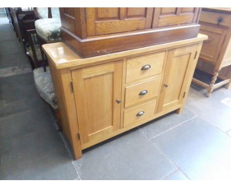 A modern light oak side cabinet. 