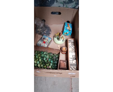 A box of collectables including a vintage Swiss musical toy, marbles, Dominoes, Rolling tin cat, chess pieces, etc. 