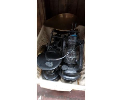A set of vintage metal weighing scales with brass trays and various weights, a storm lamp, etc. 
