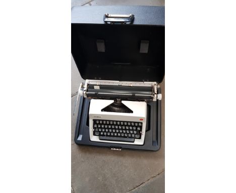 An Olympia portable typewriter, in case. 