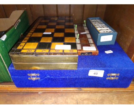 A vintage carved stone chess set together with a set of dominoes, dominoes score board and another chess set. 