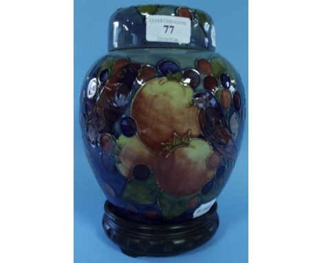 A Moorcroft pottery Finches and Fruit pattern ginger jar and cover, on a blue ground, 20 cm high, on an associated stand