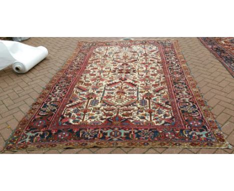 A Heriz carpet, with stylised motifs on a red ground, within a multi border, 307 x 200 cm Condition report Report by NG

Wear