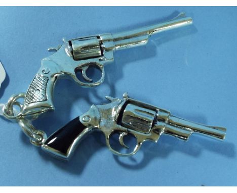 A silver keyring, in the form of a handgun, and another (2)