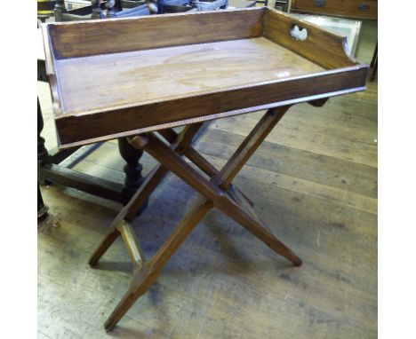 An oak butler's tray, on a folding stand, 82 cm wide