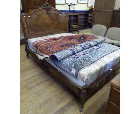 A pair of French walnut bed ends, with rococo style decoration, on dwarf cabriole legs with scroll toes, 143 cm wide Conditio