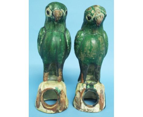 A pair of Chinese parrots, on pierced bases, with remains of wax seal, 20 cm high (2)