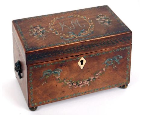 A Regency mahogany tea caddy, with painted decoration and initialled K M, with lion mask handles and on bun feet, 19 cm wide 