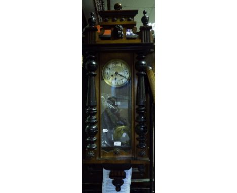 A Vienna style wall clock, the silvered dial with Roman numerals, in a walnut case, 123 cm high