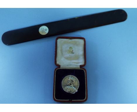 Royalty interest: A tortoiseshell page turner, inset a silver coloured metal disc, with King George and Queen Mary's initials