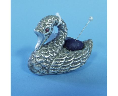 A silver pincushion, in the form of a swan, set ruby eyes