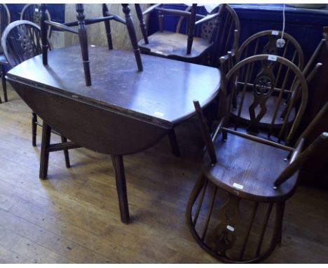 An oak dining table, a set of five wheel back chairs, an Ercol drop leaf table and four Ercol chairs (12)