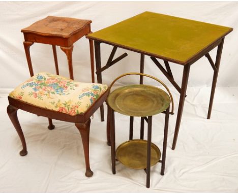 MIDDLE EASTERN FOLDING OCCASIONAL TABLEwith a fold over brass handle above a circular brass tray, standing on six legs united