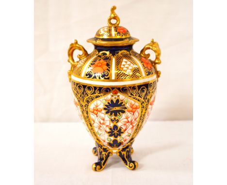 ROYAL CROWN DERBY PORCELAIN JAR AND COVER
decorated in the Imari pattern, with a gilt finial and scroll handles, 15cm high 