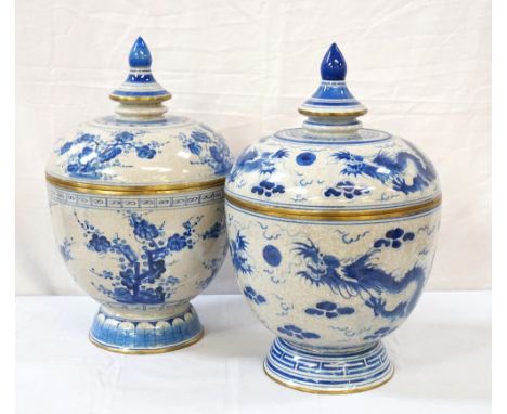 MATCHED PAIR OF CHINESE PORCELAIN JARS AND COVERSof shaped form, the lids with a brass band below the finial and the lip, the