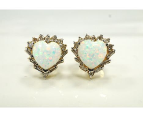 PAIR OF OPAL AND DIAMOND CLUSTER STUD EARRINGSthe central heart shaped opal on each in round and baguette cut diamond surroun