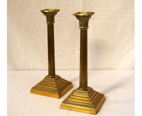 PAIR OF EDWARDIAN BRASS CORINTHIAN COLUMN TABLE LAMP BASESraised on square stepped bases, the base rims with ivorine screw-in