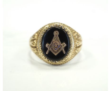 NINE CARAT YELLOW GOLD MASONIC RINGwith ornate shoulders flanking an oval set with a compass and set square, size S-T 