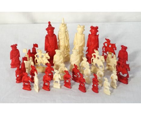 CHINESE CARVED IVORY CHESS SET comprising a natural and a red stained set, contained in a wooden box 