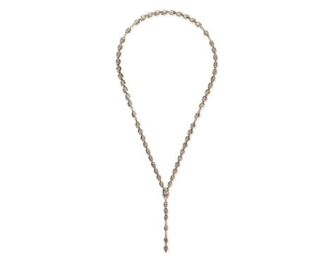 JADE JAGGER FOR GARRARD, A SKULL PENDANT NECKLACE in gold-plated silver, comprising a row of skull shaped links, suspending a