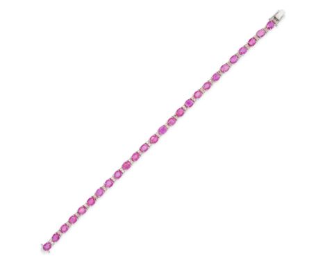 A RUBY AND DIAMOND BRACELET in 18ct white gold, comprising a row of oval cut rubies accented by pairs of round brilliant cut 