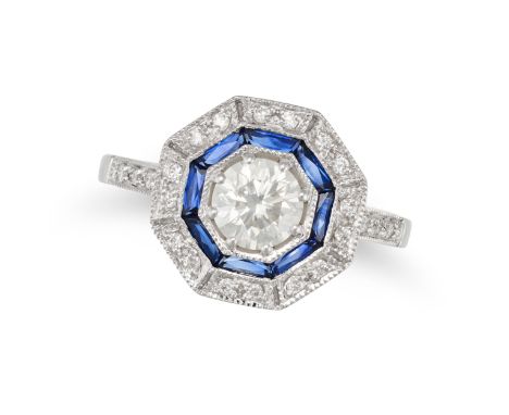 A DIAMOND AND SAPPHIRE TARGET RING in 18ct white gold, set with a round brilliant cut diamond in a concentric border of calib