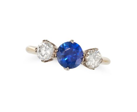 A SAPPHIRE AND DIAMOND THREE STONE RING in 18ct yellow gold, set with a round cut sapphire of approximately 1.29 carats betwe