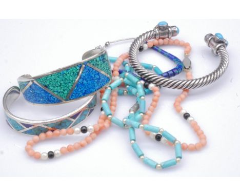 A collection of silver and gemset jewellery. Including a lapis and turquoise mosaic silver cuff bangle, a coral bead necklace