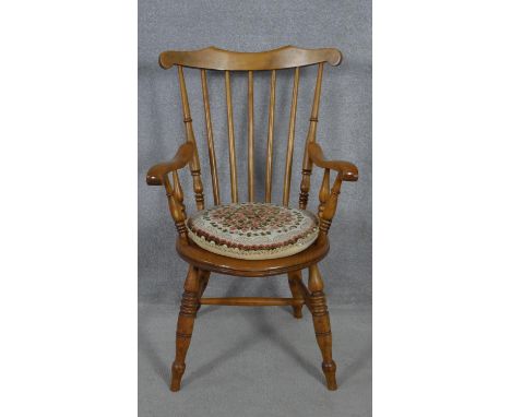 A late 19th century beech framed stick back kitchen armchair on turned stretchered supports. H.99cm 