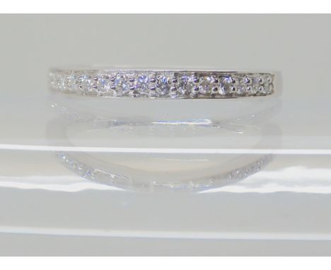 A platinum diamond set half eternity ring set with estimated approx 0.13cts, size I1/2 (I for India) weight 3gms Condition Re