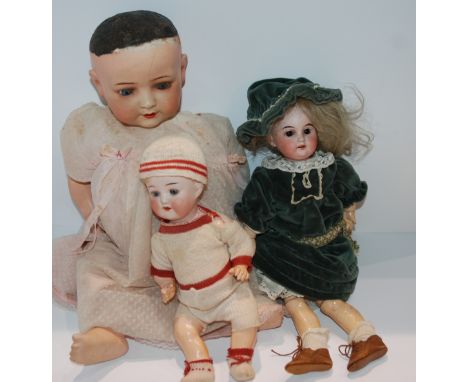 A Heubach Koppelsdorf 320.4 bisque-headed doll with impressed factory marks, 50cm high and two other bisque-headed dolls (3) 