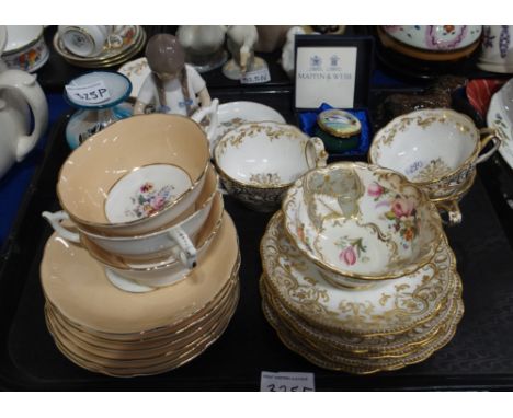 A lot comprising Coalport peachground and gilt rimmed tea cups and saucers, gilt decorated cups marked 1803 to base, a Mappin