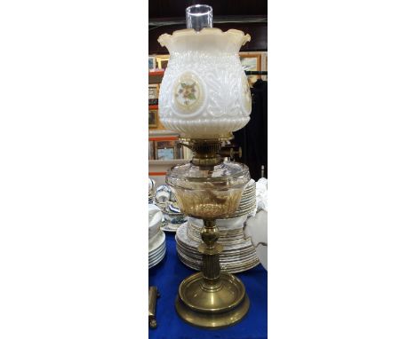 An oil lamp with brass column and an Irish linen tablecloth Condition Report: Available upon request