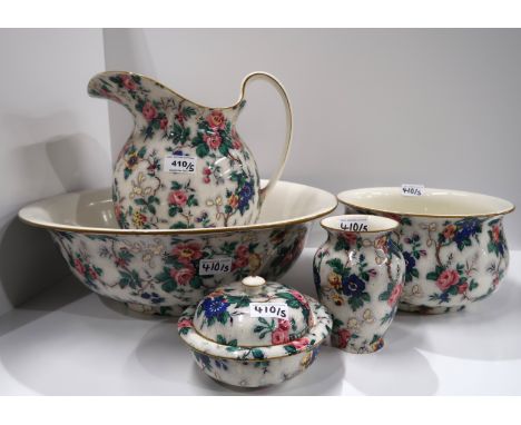 A Crown Ducal chintz wash set comprising wash bowl, ewer, chamber pot, tooth cup and soap dish and drainer Condition Report: 