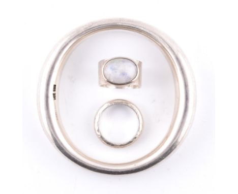 A hallmarked silver bangle and two designer silver rings. The jewellery to include a hallmarked Disa Alsopp silver and moonst