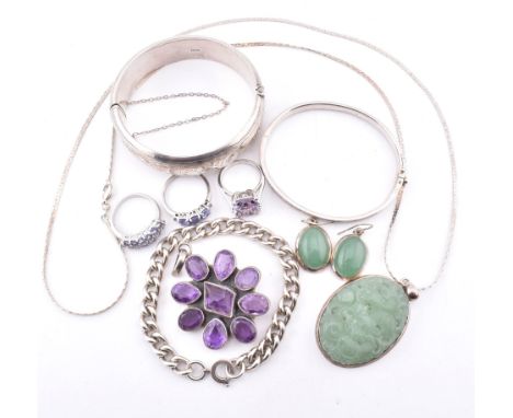A collection of silver and gem set jewellery. The jewellery to include a hallmarked engraved bangle. A CZ set hinged bangle, 