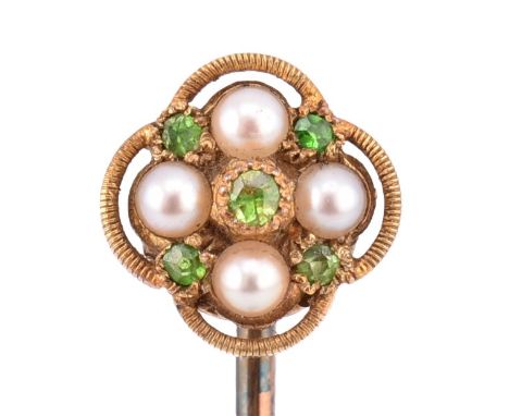 A demantoid garnet and pearl stick pin. The stick pin set with a round cut demantoid garnet surrounded by a halo formed of fo