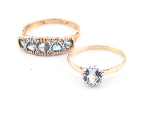 Two hallmarked 9ct gold and topaz rings. The lot to include a hallmarked 9ct yellow gold ring having five alternating facing 