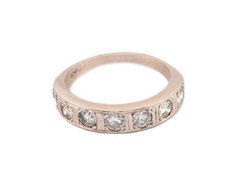 An 18ct white gold and diamond 7 stone ring. The ring set with seven round brilliant cut diamonds of approx. 0.15cts each, a 