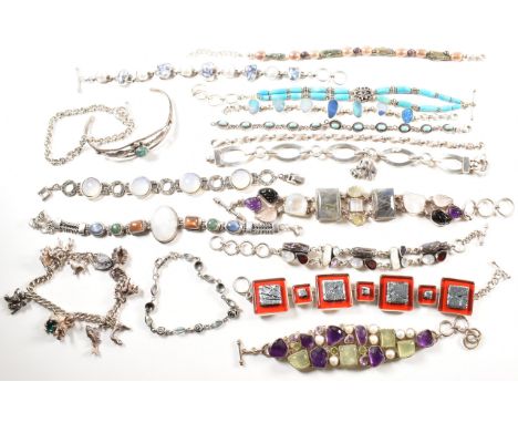 A quantity of silver gem set bracelets and a cuff bangle. The bracelets include charm, gem set pearl, amethyst, moonstone tur