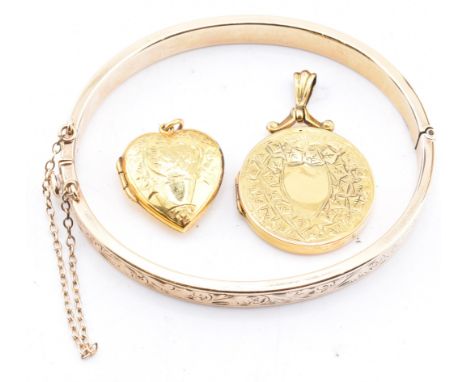 A 9ct gold core bangle and two rolled gold necklace pendants. The lot to include a 9ct gold core engraved hinged bangle with 