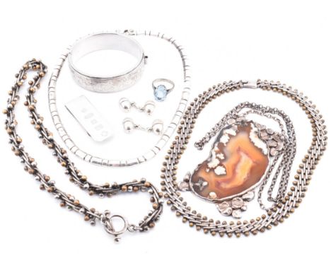 A collection of silver jewellery. The assorted silver jewellery to include a hallmarked silver engraved hinged bangle, hallma