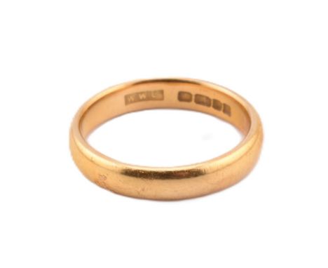A hallmarked 22ct yellow gold band ring. The 22ct yellow gold band ring hallmarked for London, 1959 together with maker's mar