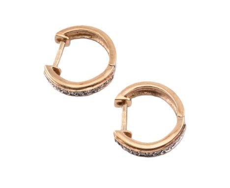 A pair of hallmarked 9ct gold and diamond hinged hoop earrings. The 9ct yellow gold earrings set with a single channel of rou