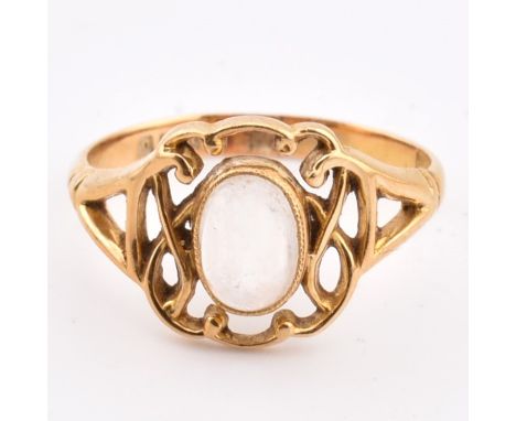 A hallmarked 18ct gold and moonstone ring. The 18ct yellow gold ring having a single oval moonstone cabochon set within a pie