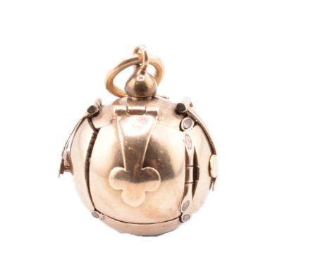 A 9ct gold on silver Masonic ball pendant. The 9ct yellow gold on silver Masonic ball/orb pendant opening to reveal a crucifo