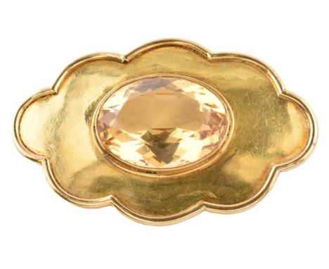 A gold and citrine brooch pin. The brooch in the form of a cloud set with a central oval mixed cut citrine. The brooch having