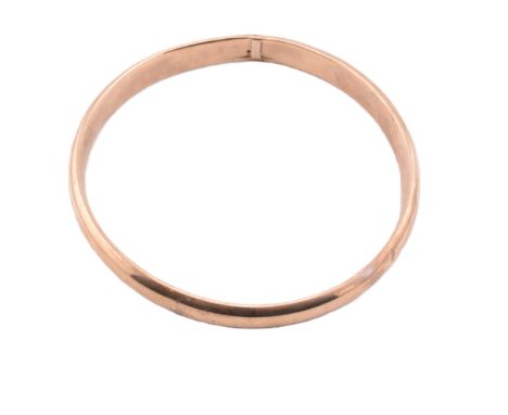 A 9ct gold wax filled bangle. The 9ct gold bangle having a polished exterior to wax-filled centre. Marked 9CT 'wax filled' to