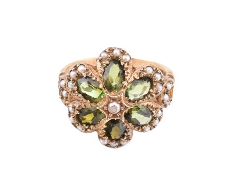 A hallmarked 9ct gold green stone and seed pearl cluster ring. The 9ct yellow gold ring set with a central five claw set pear